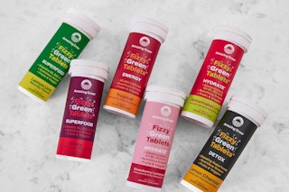 tubes with vitamin tablets on a marble table