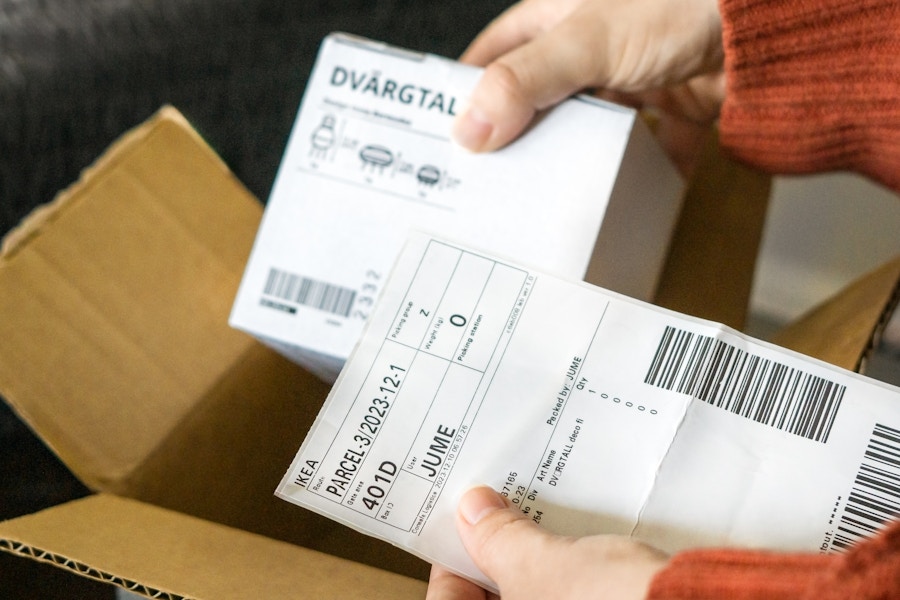 Someone looking at their receipt with their IKEA online order