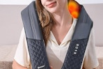 a woman using a neck massager