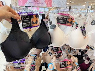 A variety of Bali bras hanging from a store rack.