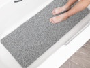 a grey and white bathmat in a bathtub 