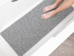 a grey and white bathmat in a bathtub 