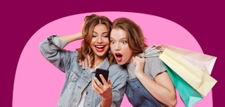 two ladies on their phone with shopping bags