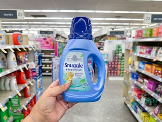 hand holding snuggle fabric softener in walgreens