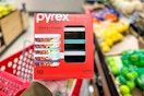 hand holding a pyrex glass meal prep set in front of a target shelf
