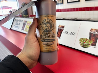 someone holding hot sauce