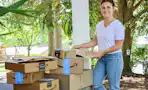 woman with stack of amazon boxes