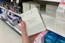 Woman holding CORA tampons in target