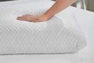 a hand on a pillow