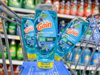 Several Gain Ultra Clean EZ Squeeze standing upright in a store cart.