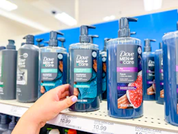 hand grabbing a dove men+care plant based body wash off a target shelf