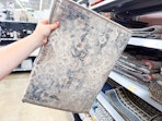 In store photo of the Mainstays Persian accent rug (held up)