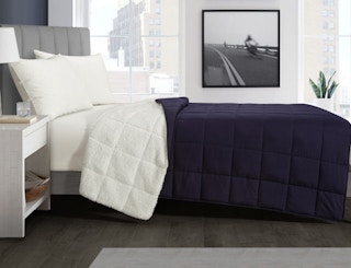 stock photo of well being weighed sherpa blanket staged on bed in bedroom