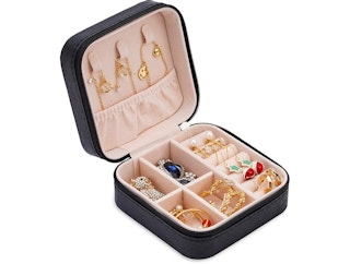Black jewelry box with jewelryon a white background
