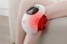 Woman wearing the CuPiLo Knee Massager with Heat on her knee.