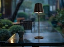 a cordless lamp on a patio table outside
