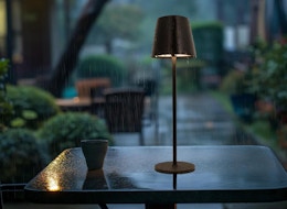 a cordless lamp on a patio table outside