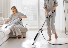 people cleaning a floor and couch with steam mops 