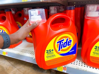 hand holding tide liquid detergent at walmart