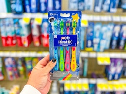 hand holding oral-b kids toothbrush pack