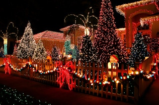 a house is lit up with christmas lights