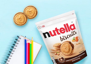 a bag of Nutella biscuits next to two biscuits and a notebook