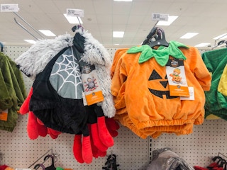 Infant Halloween costumes hanging on a display in Target.