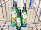Herbal Essences leave-in conditioner, hair oil, and hair spray in a Walmart cart