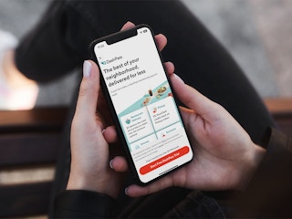 someone holding a phone displaying the app page for DoorDash Dash Pass