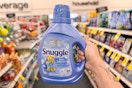 person holding a large bottle of snuggle fabric softener in an aisle