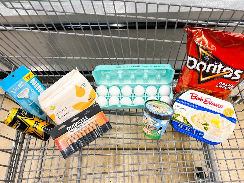 energy drink, razors, eggs, batteries, ice cream, doritos and more in a cart