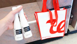 hand holding nexxus humectress conditioners in walgreens