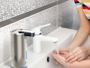 a automatic soap dispenser on a kitchen sink