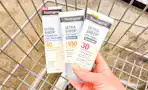 hand holding neutrogena sunscreen in cvs