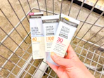 hand holding neutrogena sunscreen in cvs