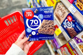 person holding a box of fiber one brownies
