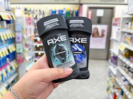 hand holding axe deodorants in walgreens