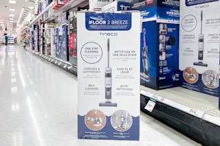 tineco cordless we/dry vacuum sitting on the floor in front of a target shelf