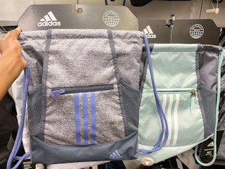 adidas drawstring backpacks on hangers in store