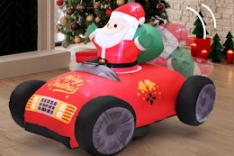 KLYLOP Remote Control Christmas Toy next to a Christmas tree.