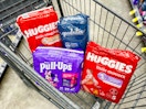packs of huggies, goodnites, and pull-ups in a shopping cart