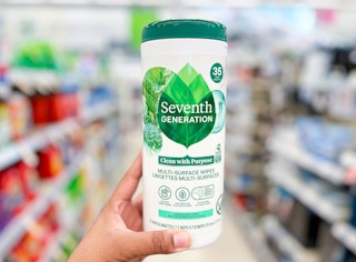 hand holding container of Seventh Generation Multi Surface wipes in aisle