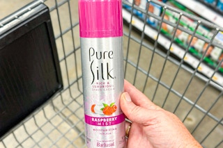 hand holding a can of pure silk shaving cream