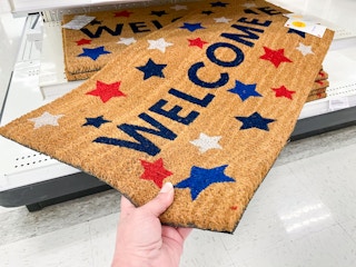 red white and blue stars with the word Welcome on a brown mat