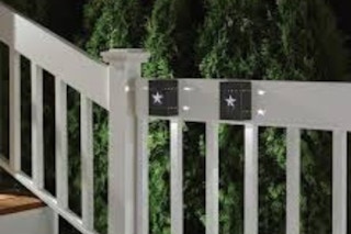 lifestyle image of 2 deck lights on a railing