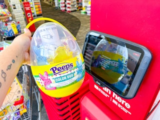 person holding a peeps activity egg set by the price scanner