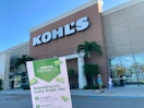 Kohls cash rewards coupon being help up in front of kohls store