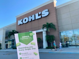 Kohls cash rewards coupon being help up in front of kohls store