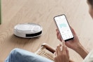 someone controlling the Lefant Robot Vacuum Cleaner with their phone