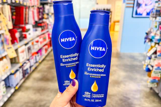 person holding 2 nivea lotions in an aisle